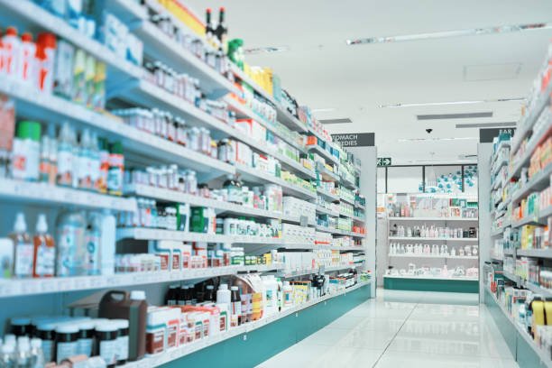 cropped shot of fully stocked shelves in an aisle of a pharmacy